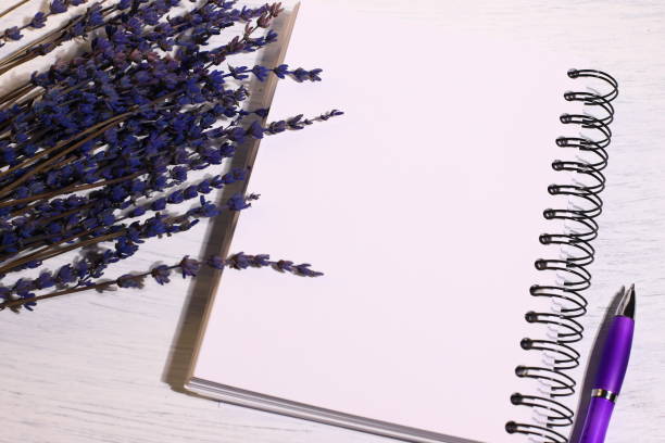 istock Notebook pen and lavender flowers on desk 1434072452