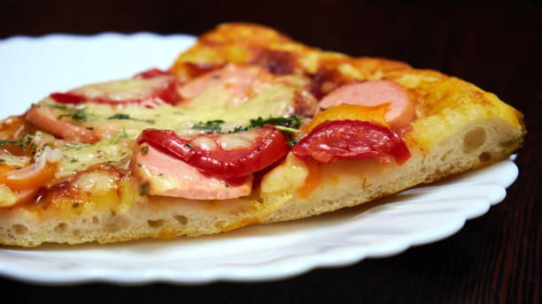 istock A piece of pizza on a white plate 1434075429