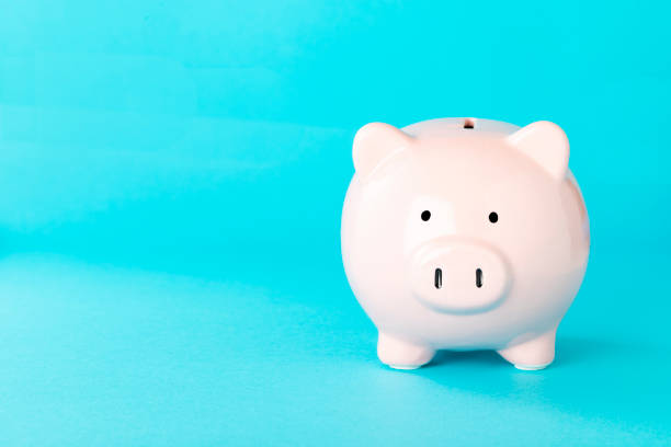 istock Coin bank isolated with copy space on blue background 1434075503