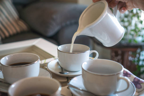 istock close-up of pitcher pouring milk into coffees 1434075553