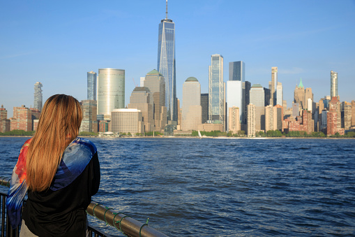 Pretty  active women Long blonde hair enjoying  in  Panorama of New York City skyline Lower Manhattan and the Freedom Tower Panoramic