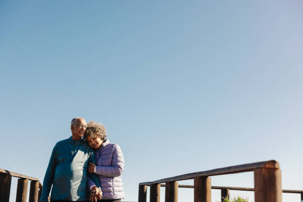 istock Loving senior couple taking a walk along a bridge at the beach 1434077968