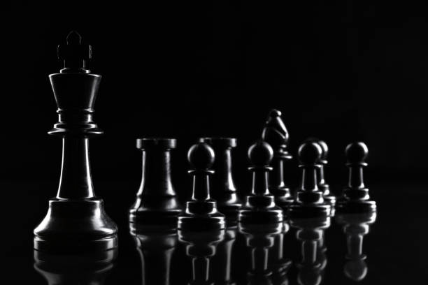 istock Chess figures on dark black background close up 1434078133