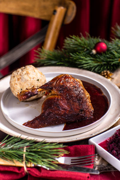 istock Christmas dinner roast duck goose turkey with orange slices, red cabbage and German dumpling 1434080073