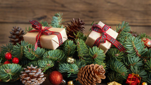 istock Wrapped gift boxes on reen fir branches near Christmas decorations and pine cones 1434080690