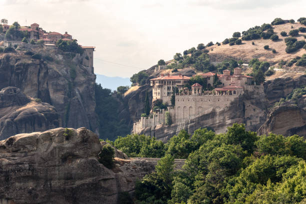 istock View from main observation point of Meteora over the hills and cliffs with Holy Monasteries of Varlaam on the right and Great Meteoron on the upper left, Kalambaka, Central Greece 1434085404