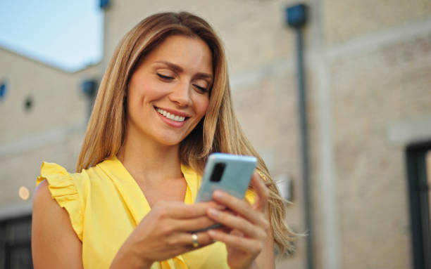 istock Beautiful woman texting on the street 1434091958