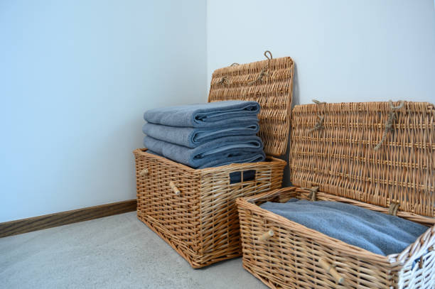 istock Stack navy blue bath towels in wicker basket on the floor. copy space. 1434092124