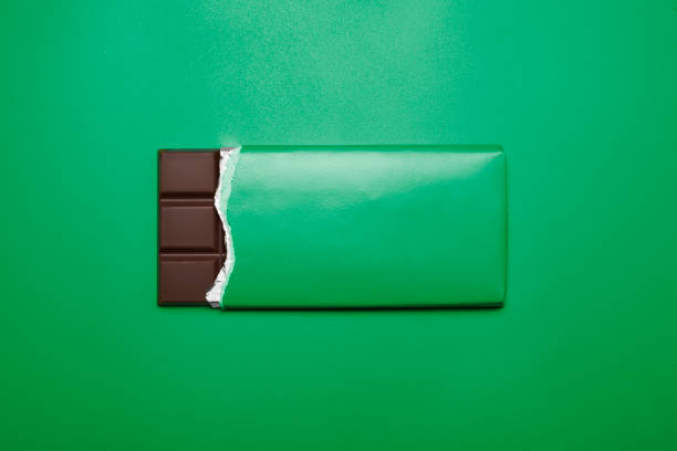 istock bar of chocolate on green background 1434094181