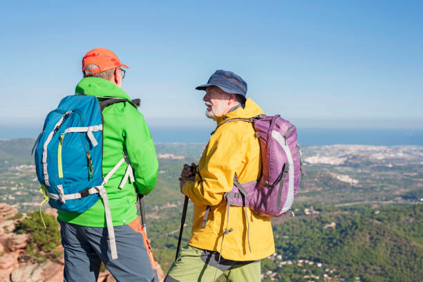 istock Two elderly hikers with backpacks standing on the valley 1434095843