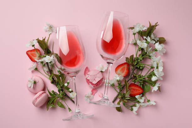 istock Wine, macaroons, strawberry and flowers on pink background 1434097574