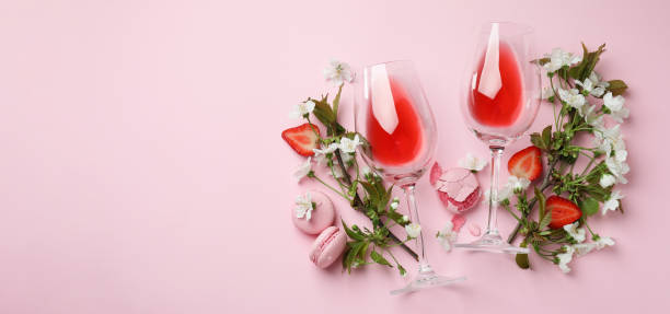 istock Wine, macaroons, strawberry and flowers on pink background 1434098108