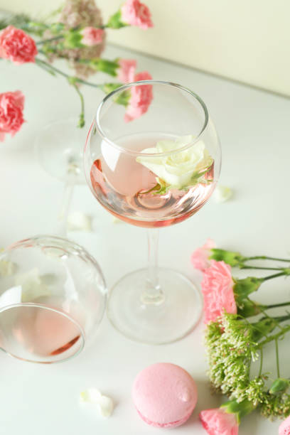 istock Wine, sweet food and flowers on white table 1434098201