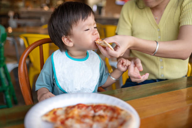 istock Infant baby boy having pizza in the restaurant 1434098214