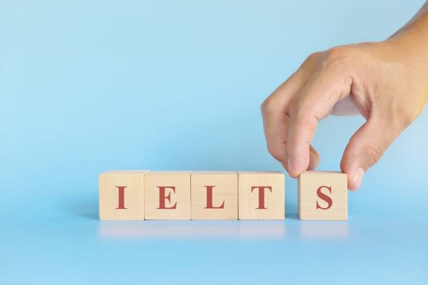 istock IELTS or international english language testing system exam or test concept. Wooden blocks typography flat lay on blue background. 1434098503