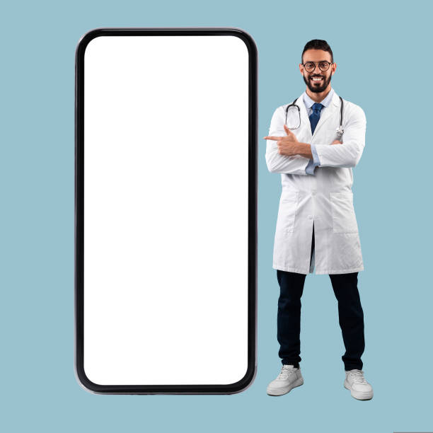 istock Doctor pointing at big white empty smartphone screen, mock-up 1434098755