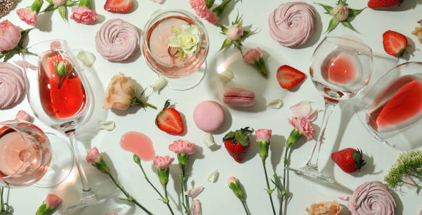 istock Wine, sweet food and flowers on white table 1434100781