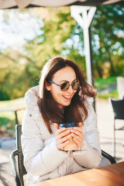 istock Beautiful woman drinking coffee in the outdoors cafe 1434100830