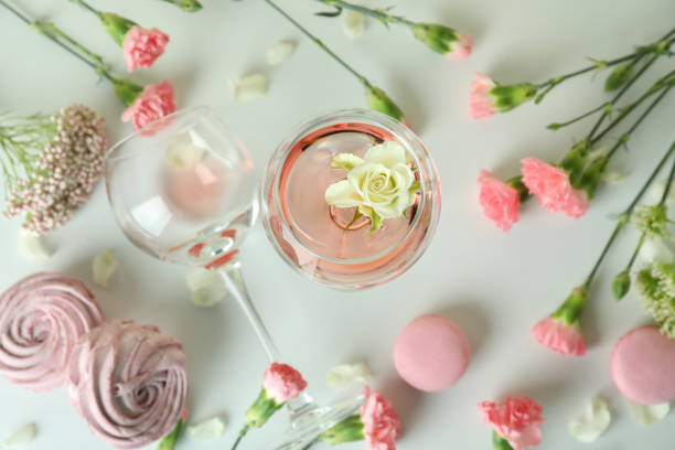 istock Wine, sweet food and flowers on white table 1434100873