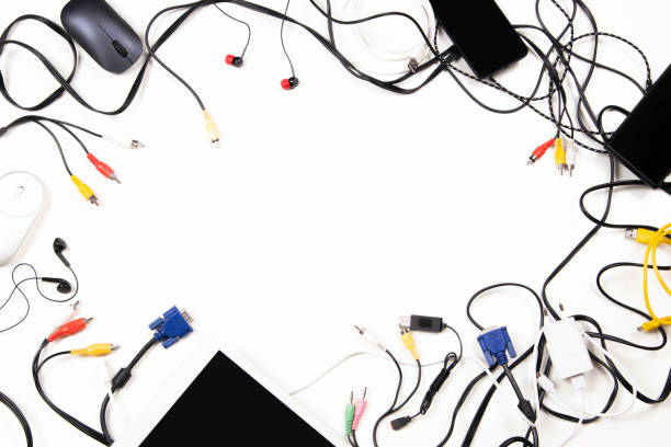 istock Top view to old digital tablet, mobile phones, cable, cords, used electronic gadgets devices on white table. Planned obsolescence, e-waste, electronic waste for recycling concept 1434104837