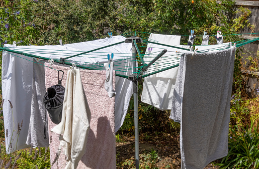 Laundry drying on rotary dryer on a sunny day in England.