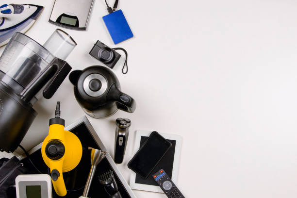 Old household, electrical appliances, broken computers, tablets, phones, used electronic gadgets devices on white background. Top view. Electronic waste for recycling, planned obsolescence concept.