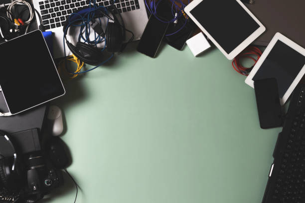 istock Top view to old laptop computers, digital tablets, mobile phones, many used electronic gadgets devices on green background. Planned obsolescence, electronic waste for recycling concept 1434105043