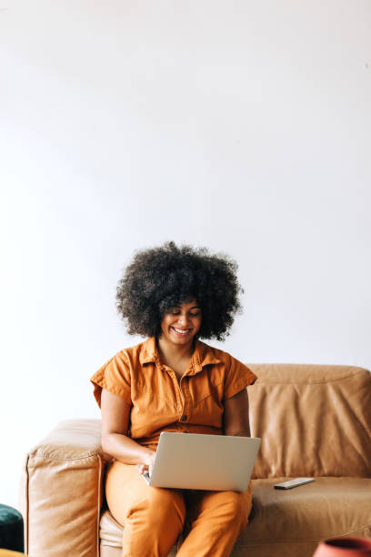 istock Happy young businesswoman smiling while working on a laptop 1434105861