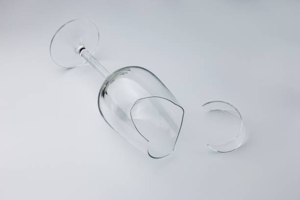 istock Broken wine glass with a shard on a light isolated background 1434105926