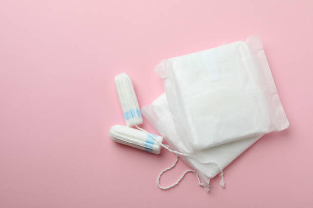 Sanitary pads and tampons on pink background Sanitary pads and tampons on pink background menses stock pictures, royalty-free photos & images