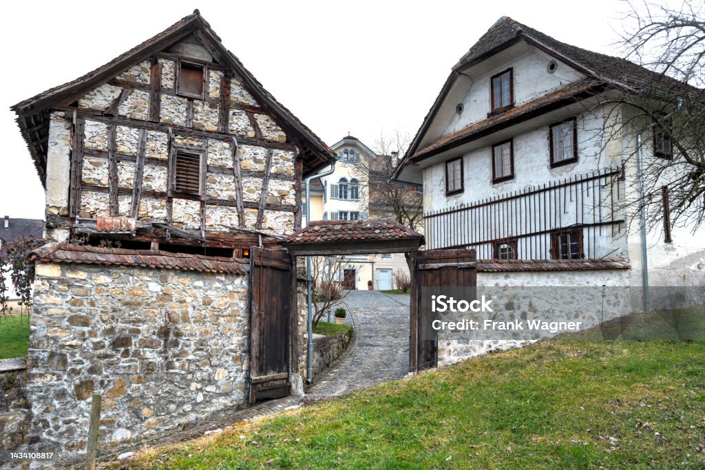 Hof The entrance to an old farm with gate and half-timbered house Agriculture Stock Photo