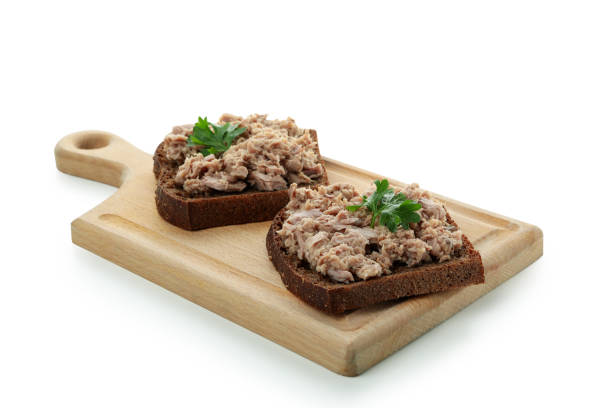 istock Board with sandwiches with canned tuna isolated on white background 1434109079