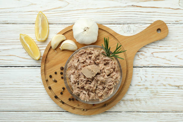 istock Bowl with canned tuna on white wooden background 1434110231