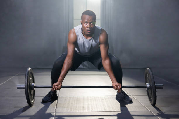 istock Black Man Holding Barbell Ready For Weight Lifting Workout 1434112913