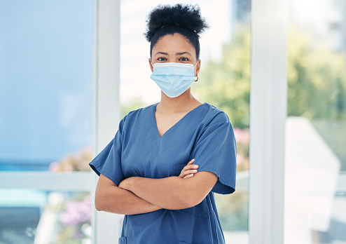 Nurse, healthcare black woman with a covid face mask in confident portrait. Innovation, leadership and proud medical nursing professional, surgeon or health employee with vision for success in career