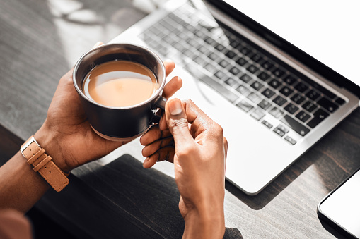 Laptop, keyboard or hands of black man with coffee to relax, drink or enjoy during morning work break. Cup of tea for person working on social media content writing, online blog or digital seo mockup