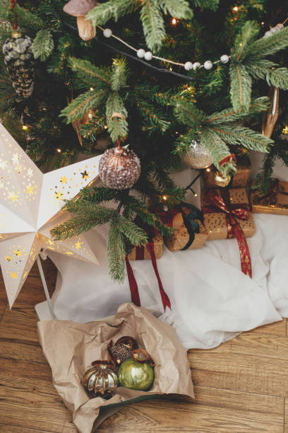 istock Box with christmas baubles in atmospheric festive room under christmas tree. Decorating christmas tree with vintage ornaments. Merry Christmas! Winter holidays preparation 1434115029