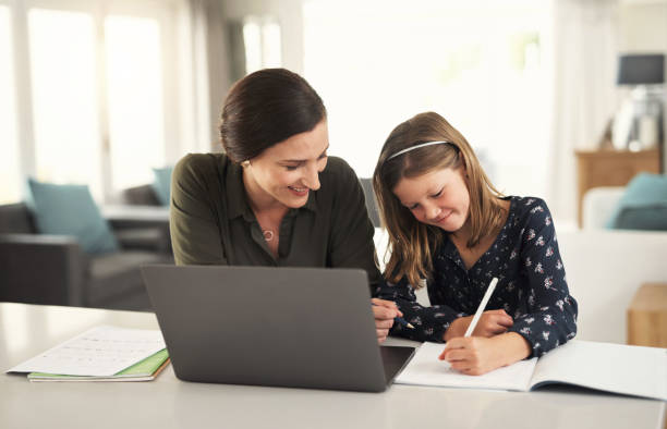 istock Mother, help and girl online learning on laptop for knowledge, education and child development at home. Smile, education and happy student drawing, writing and studying in notebook with moms support 1434115092