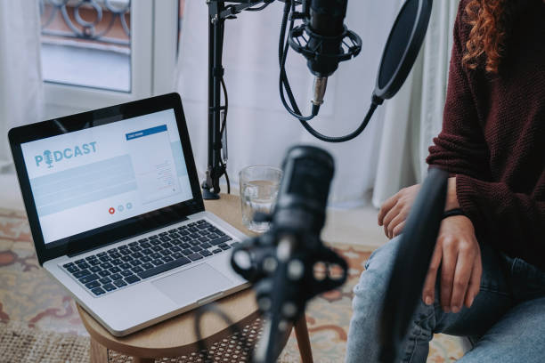 istock Host recording radio podcast interview with guest at home studio - Focus on computer laptop screen 1434115344