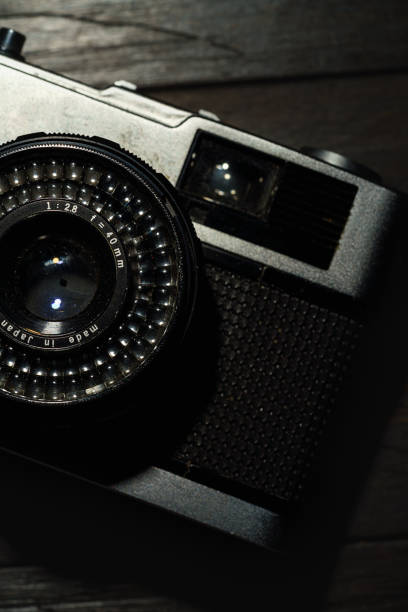 istock Old film camera isolated on dark background 1434115404