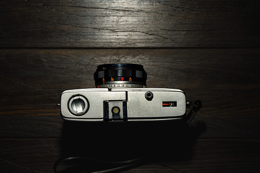 Old film camera isolated on dark background
