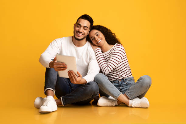istock Online Entertainment. Happy Young Middle Eastern Couple Using Digital Tablet Together 1434115509