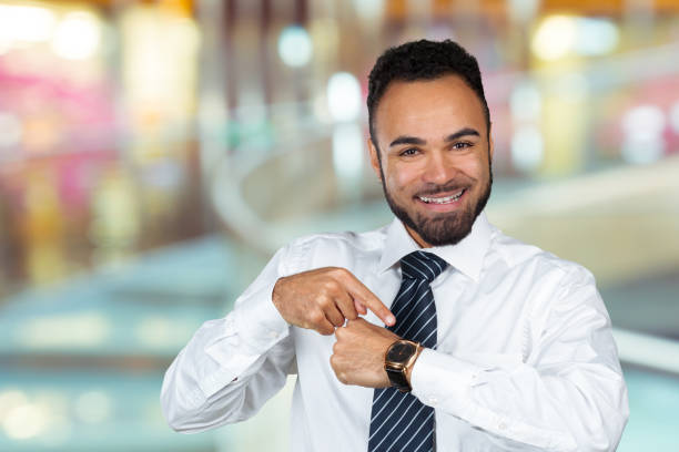 istock Businessman pointing at his watch, time management concept 1434116010
