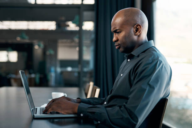 istock Businessman, thinking or laptop in office boardroom in company web design, target audience research or kpi data analysis. Worker, employee or programmer on digital marketing technology or seo website 1434116598