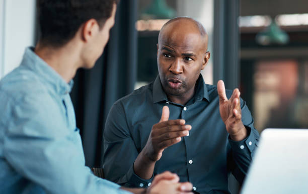 Businessman, leadership and business meeting for teamwork, motivation or collaboration for innovation strategy. Consulting, CEO or mentor working with employee for creative KPI data analytics review Businessman, leadership and business meeting for teamwork, motivation or collaboration for innovation strategy. Consulting, CEO or mentor working with employee for creative KPI data analytics review black man giving speech stock pictures, royalty-free photos & images