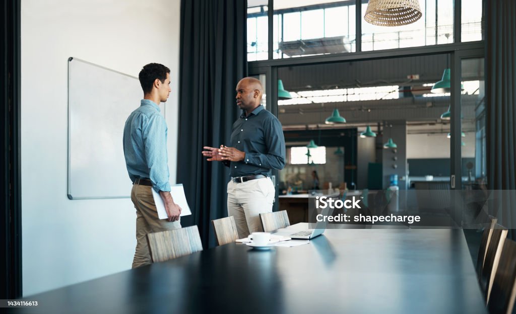Businessman leadership speaking to employee as mentor, coaching and training in corporate company, office planning or discussion. Assertive black manager talking in conversation with staff in startup Discussion Stock Photo