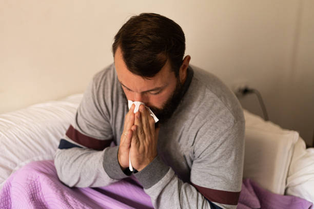 istock A sick man from a virus is at home 1434116653