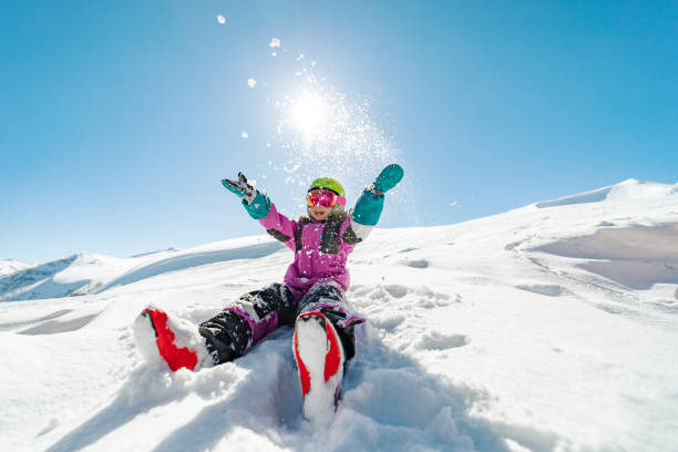 Little girl having fun at ski resort stock photo