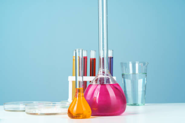 istock Chemical laboratory glassware with various colored liquids on table 1434118795