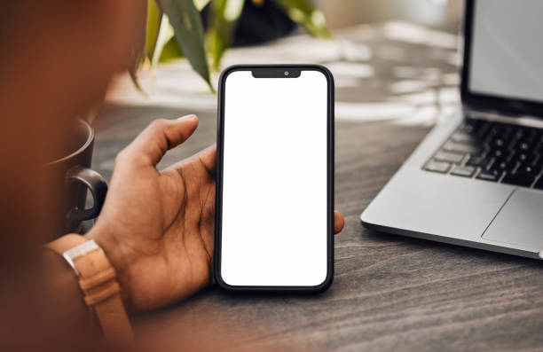 istock Blank phone green screen and mockup space of a mobile screen in a office using technology. Busy woman employee hand working on social media content app scroll and contact planning a digital project 1434119026